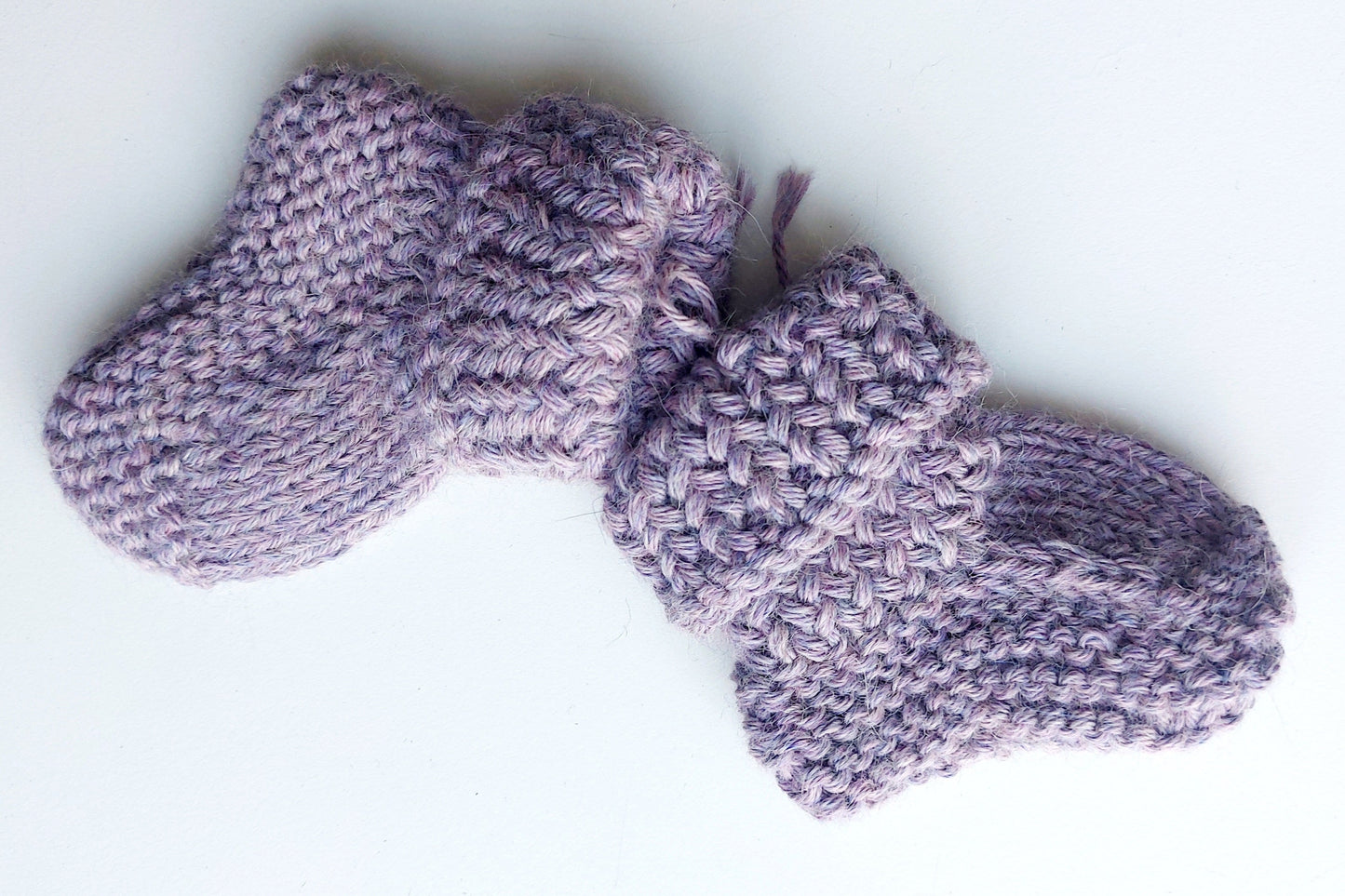 Handmade knitted baby socks in lila with folded ankle cuffs, made from 100% baby alpaca wool—soft, stretchy, and perfect for little feet.
