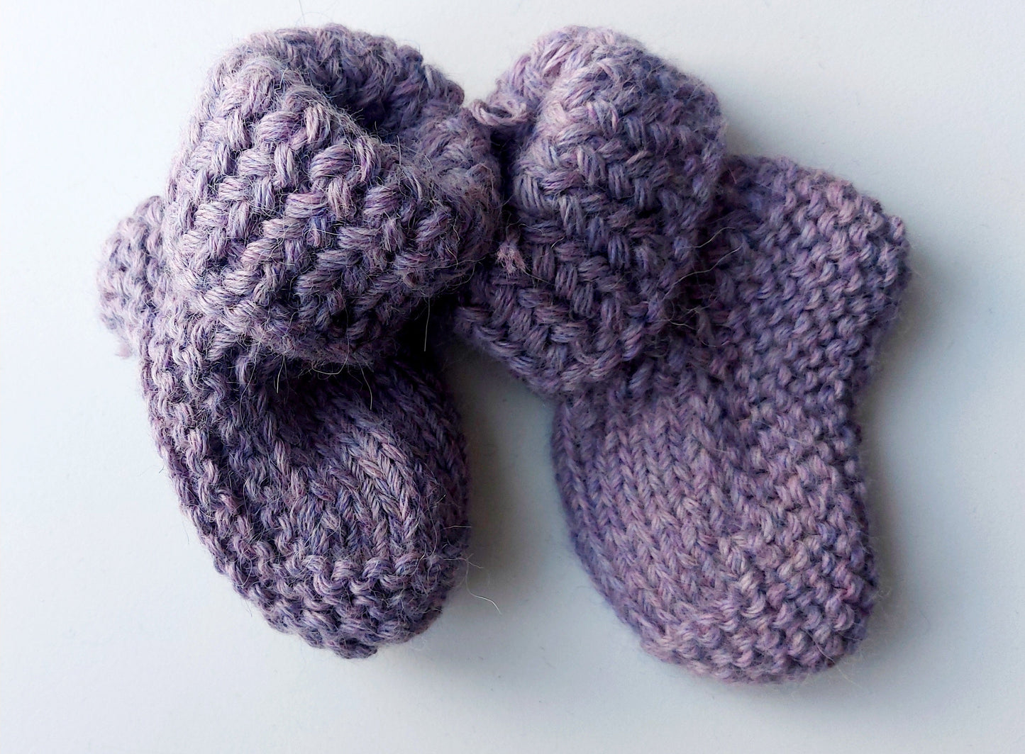 Handmade knitted baby socks in lila with folded ankle cuffs, made from 100% baby alpaca wool—soft, stretchy, and perfect for little feet.
