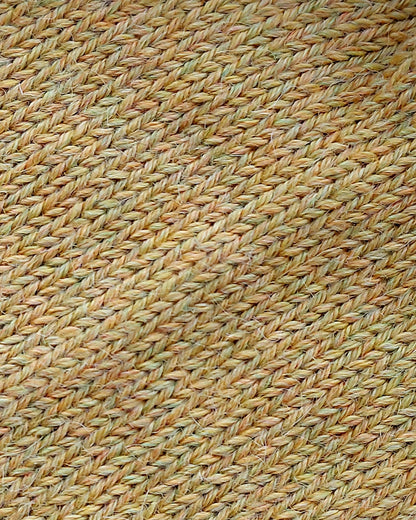 Close-up of the soft knitted texture of the handmade light yellow baby hat, made from 100% baby alpaca wool.