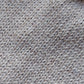 Close-up of the knitted texture of a light brown baby hat, made from 100% baby alpaca wool.