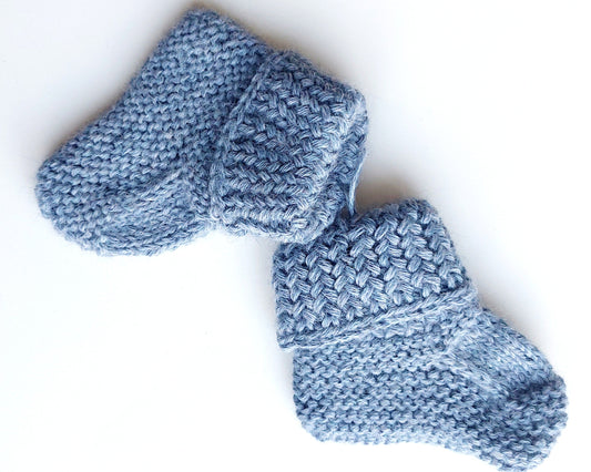Handmade knitted baby socks in light blue with folded ankle cuffs, made from 100% baby alpaca wool—soft, stretchy, and perfect for little feet.
