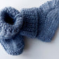 Handmade knitted baby socks in light blue with folded ankle cuffs, made from 100% baby alpaca wool—soft, stretchy, and perfect for little feet.