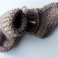 Handmade knitted baby socks in light brown with folded ankle cuffs, made from 100% baby alpaca wool—soft, stretchy, and perfect for little feet.