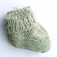 Handmade knitted baby socks in light green with folded ankle cuffs, made from 100% baby alpaca wool—soft, stretchy, and perfect for little feet.

