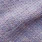 Close-up of the soft knitted texture of the handmade lila baby hat, made from 100% baby alpaca wool with a foldable edge and pompom.
