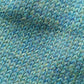 Close-up of the knitted texture on the handmade peacock blue baby hat, made from 100% baby alpaca wool.