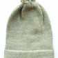 Handmade light green baby hat in soft 100% baby alpaca wool with a pompom, foldable edge, and brown vegan leather label, offering warmth and style.
